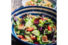 resh garden salad with cherry tomatoes, cucumber, croutons, and mixed greens served in a bowl